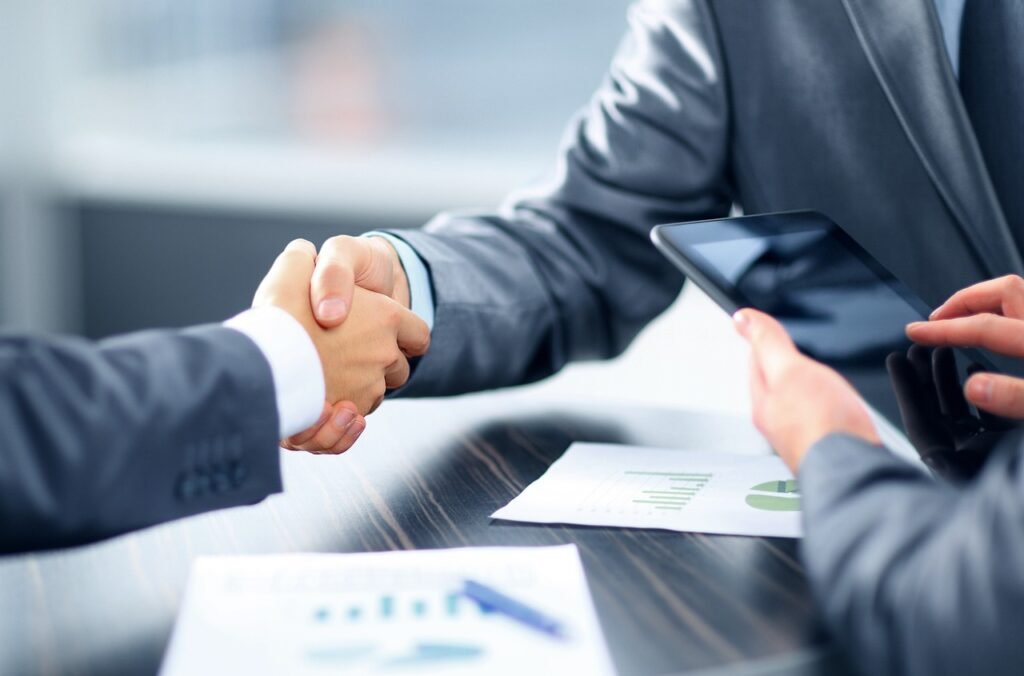 Business handshake in corporate – sales and deals closing partnership