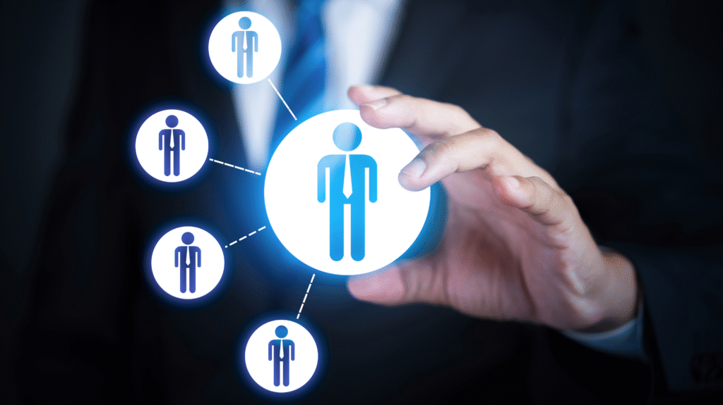 Businessman selecting human resource icon from digital network, symbolizing HR system and workforce management